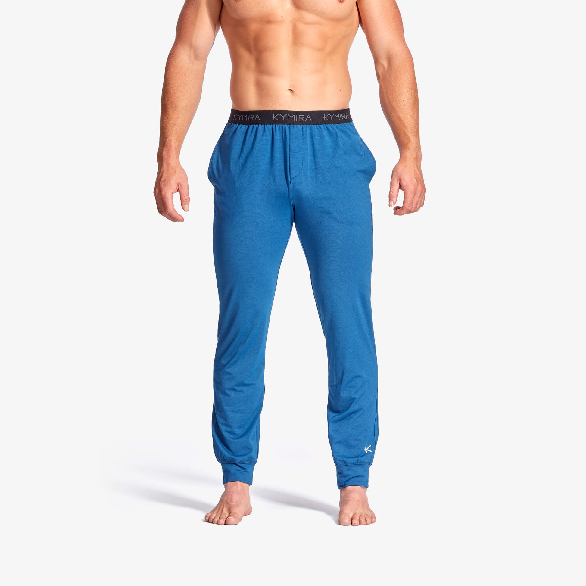 Man wearing blue pajama pants on a white background