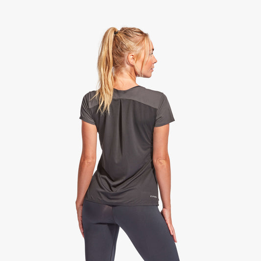 Woman wearing a black athletic outfit on a white background