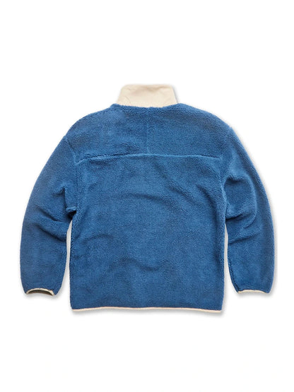 Blue fleece jacket with white trim on a white background